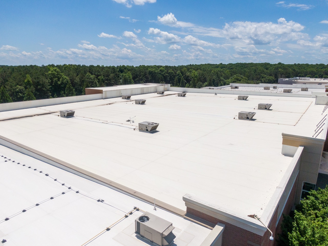 Drone Images of Commercial Roofs Featuring TPO and Asphalt Shingles: Midday, Sunny, No People